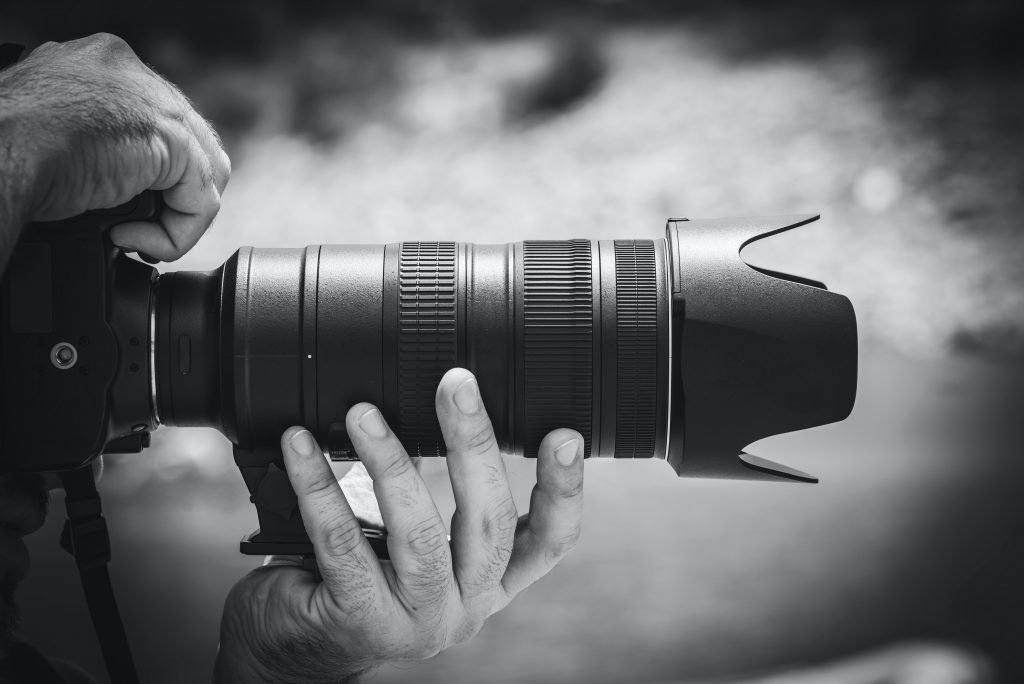 Hands holding a zoom lens