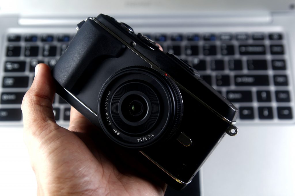Black canon dslr camera on persons hand