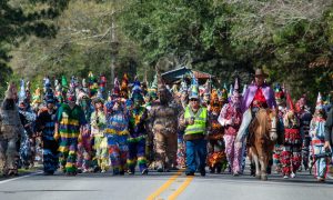 The Cajun Mardi Gras Runners in traditional, colorful garb