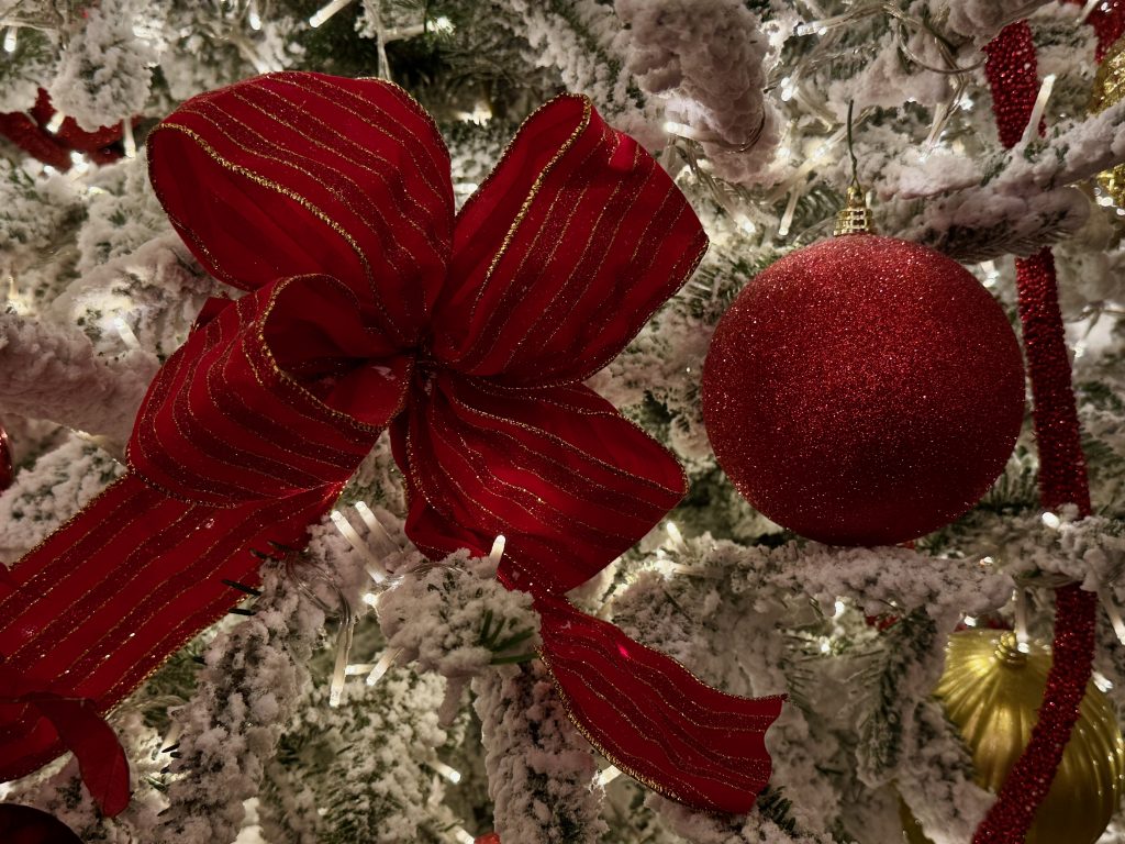 Christmas Red bow, and red and golden balls on white Christmas Tree