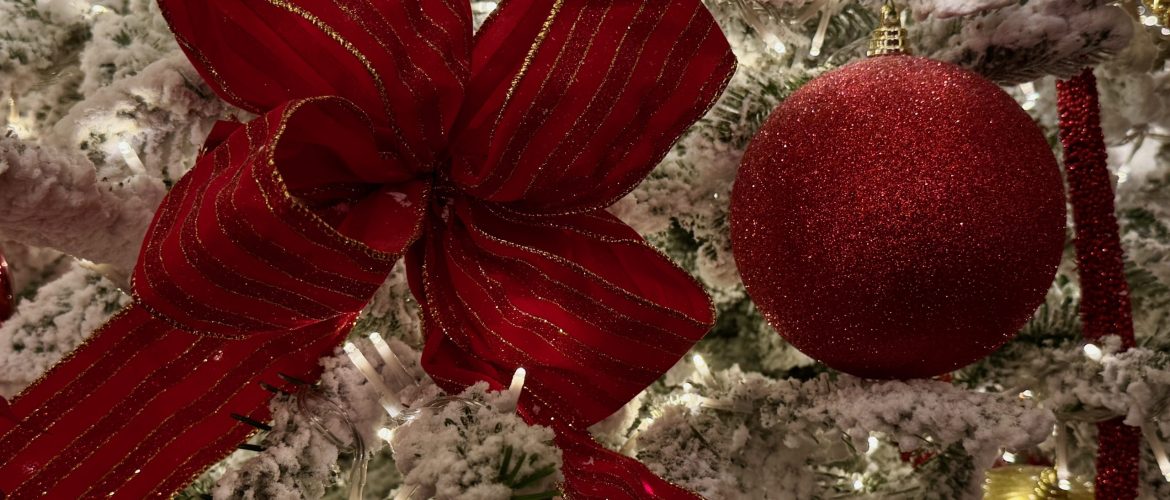 Christmas Red bow, and red and golden balls on white Christmas Tree