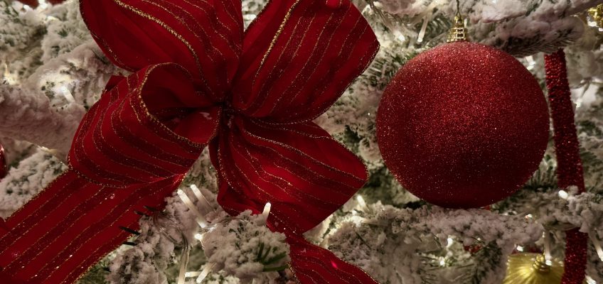 Christmas Red bow, and red and golden balls on white Christmas Tree